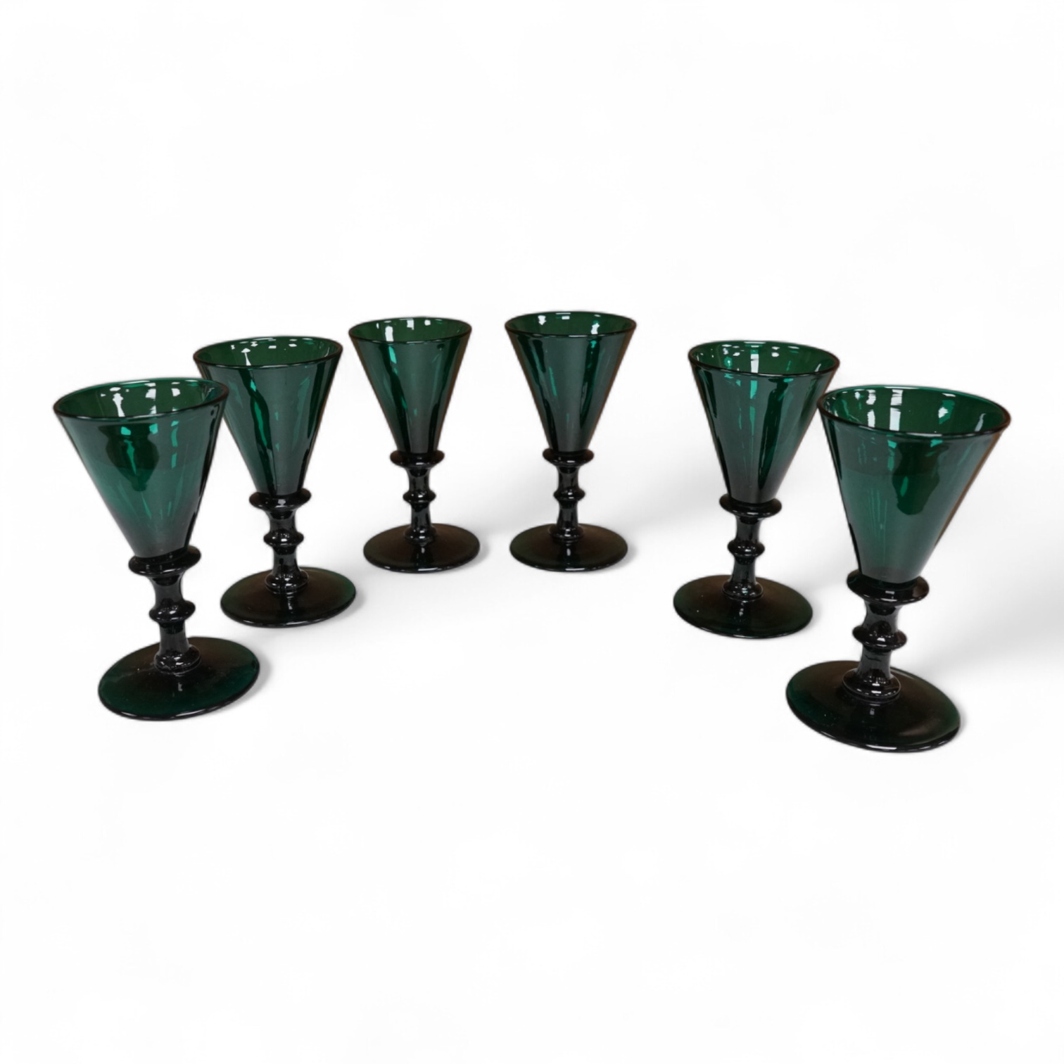 A late Georgian set of six green glasses, 13cm high